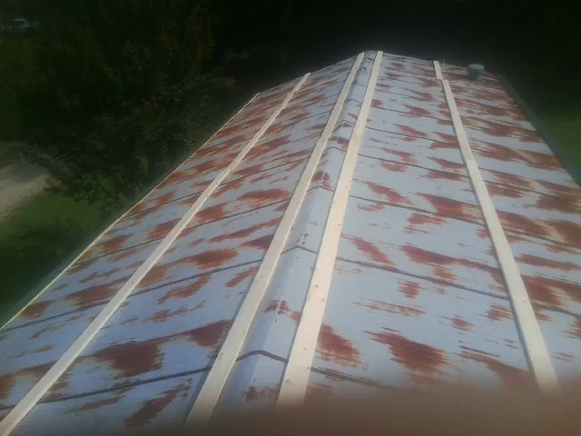 Rusted metal roof panels with new wood purlins before replacement — Storm Damage Roof Repair in Bartow by Roofing Brothers